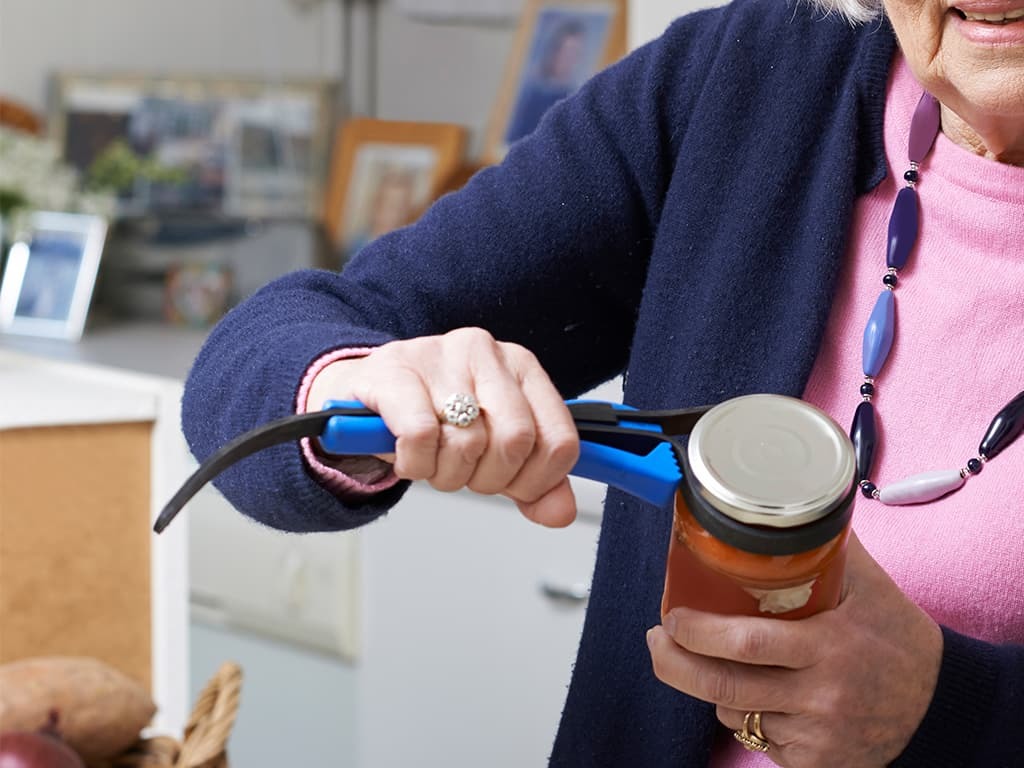 Woman with ALS opening a jar with kitchen aid