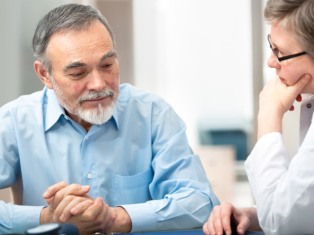 ALS patient talking to a doctor